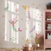 Whimsical mermaid wall decals with rainbows, stars, and sea creatures in pastel colors.